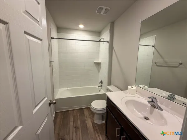 a bathroom with a sink toilet tub and shower
