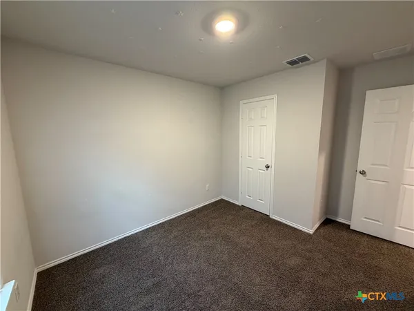 an empty room with a empty space and window