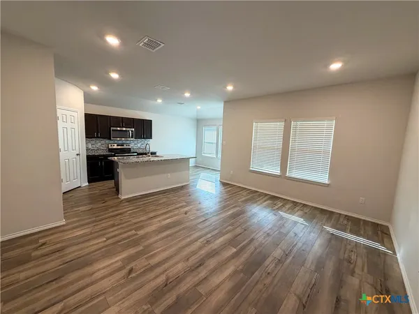 a view of kitchen with sink and wooden floor