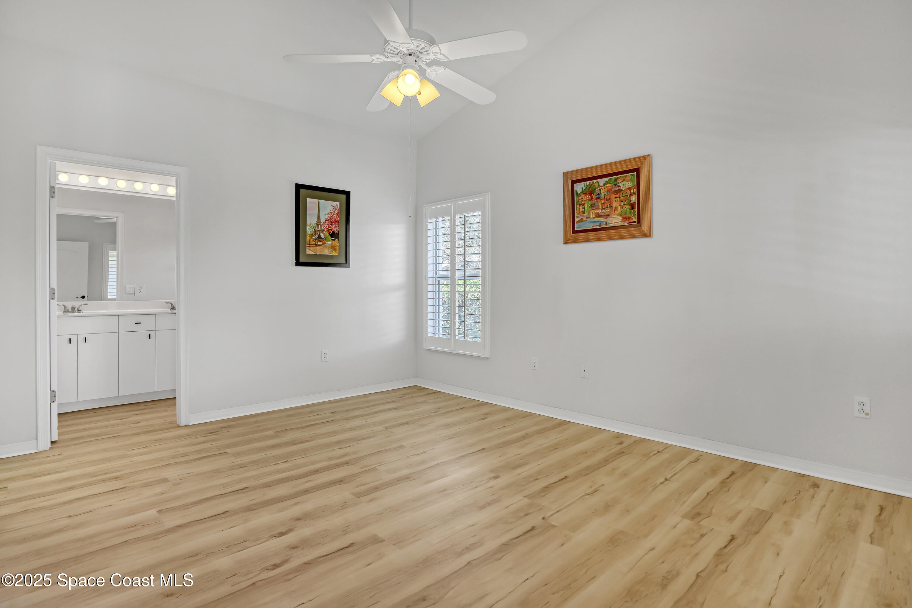 1692 Keys Gate Drive Melbourne, FL 32940 - Photo 14 of 26 a view of empty room with wooden floor and fan
