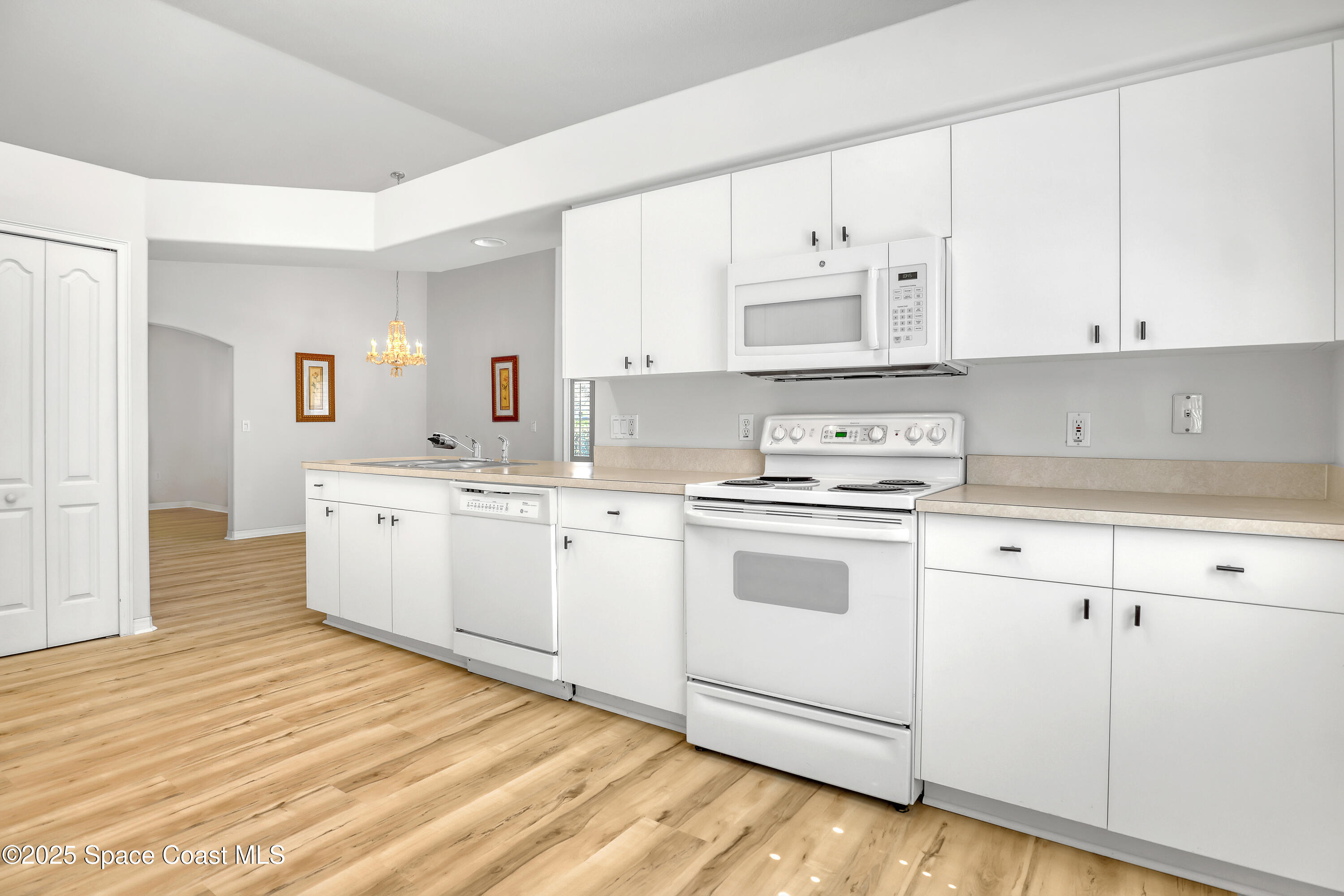 1692 Keys Gate Drive Melbourne, FL 32940 - Photo 16 of 26 a kitchen with granite countertop white cabinets and white appliances