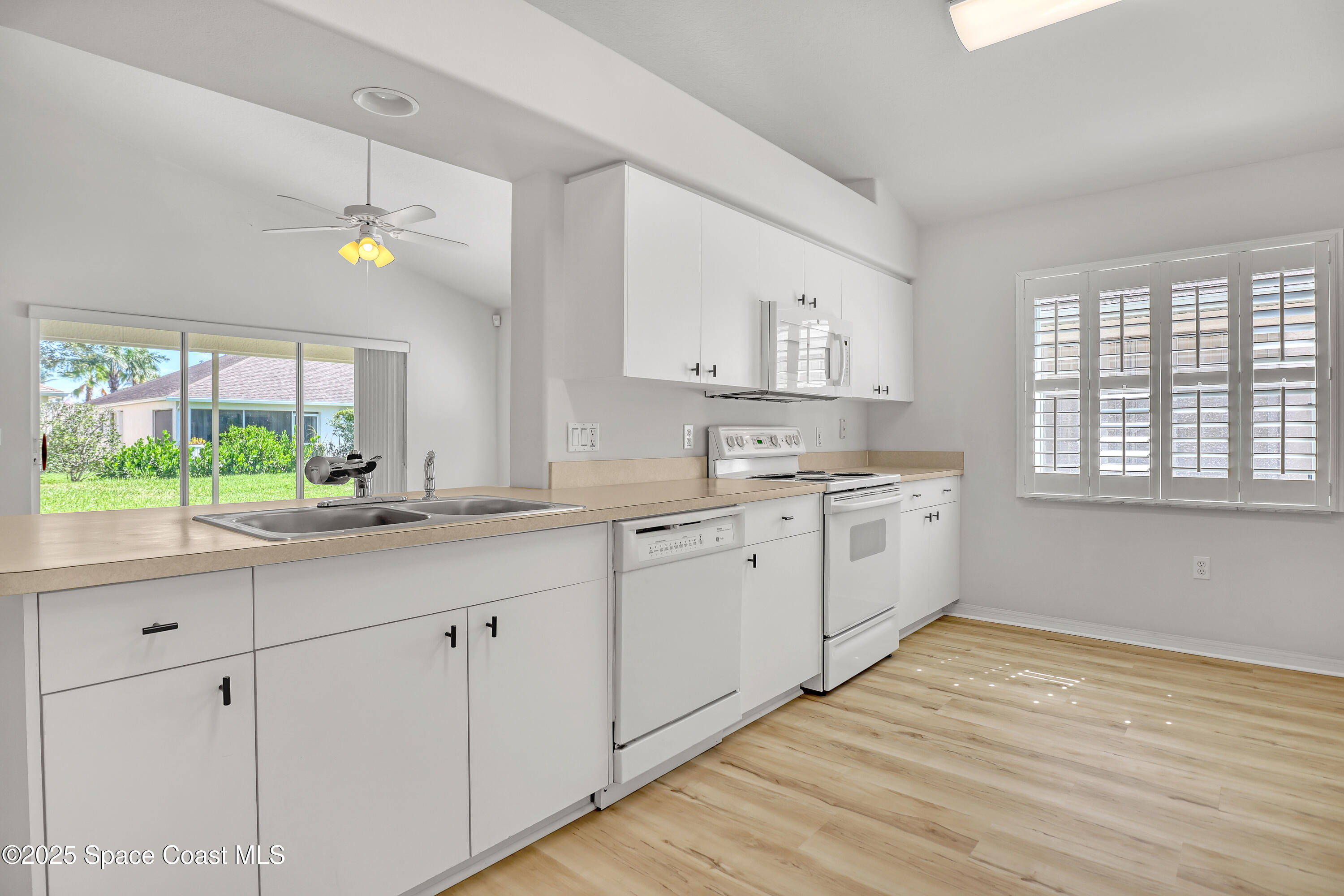 1692 Keys Gate Drive Melbourne, FL 32940 - Photo 18 of 26 a kitchen with white cabinets and window