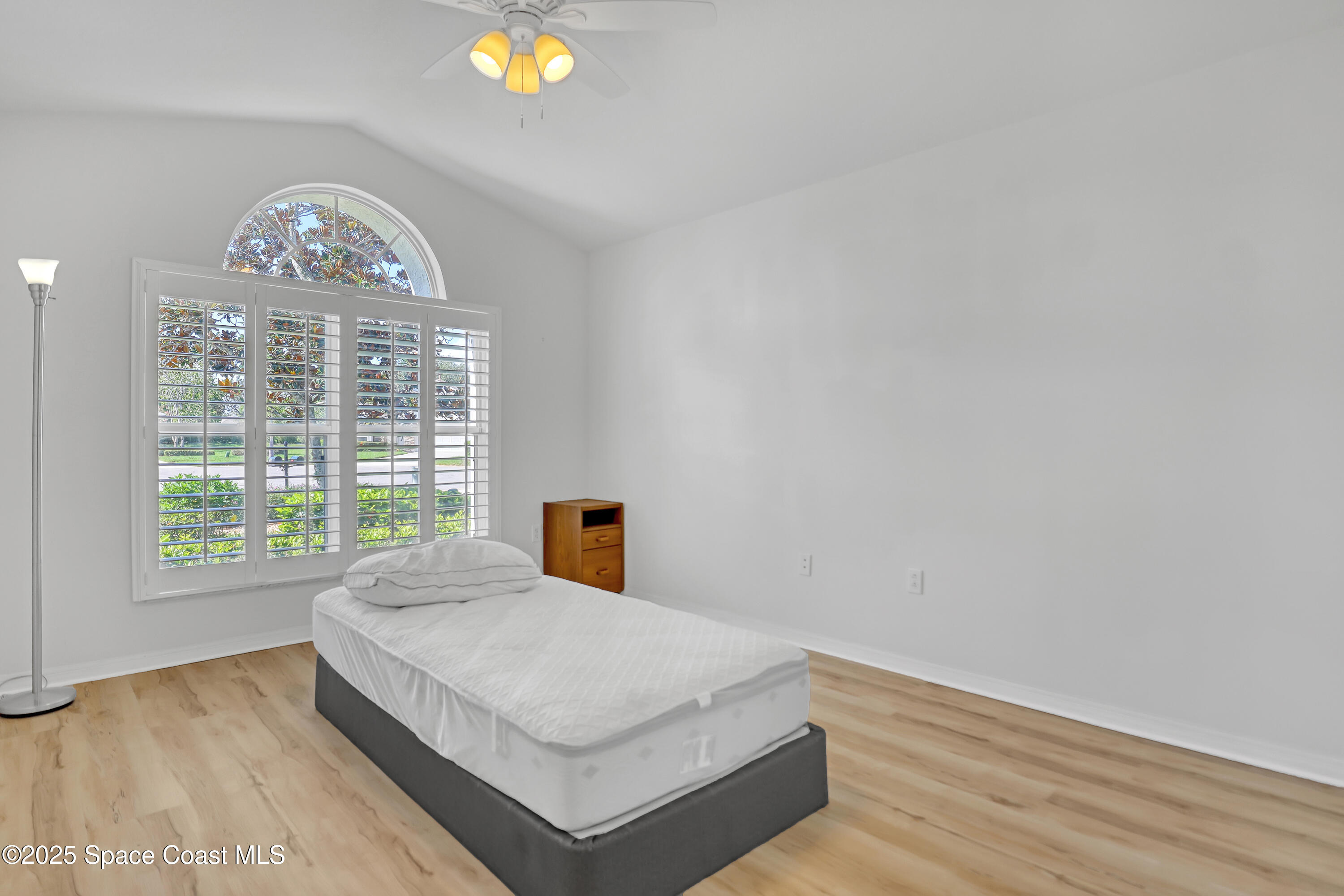 1692 Keys Gate Drive Melbourne, FL 32940 - Photo 21 of 26 a bedroom with a bed and a window