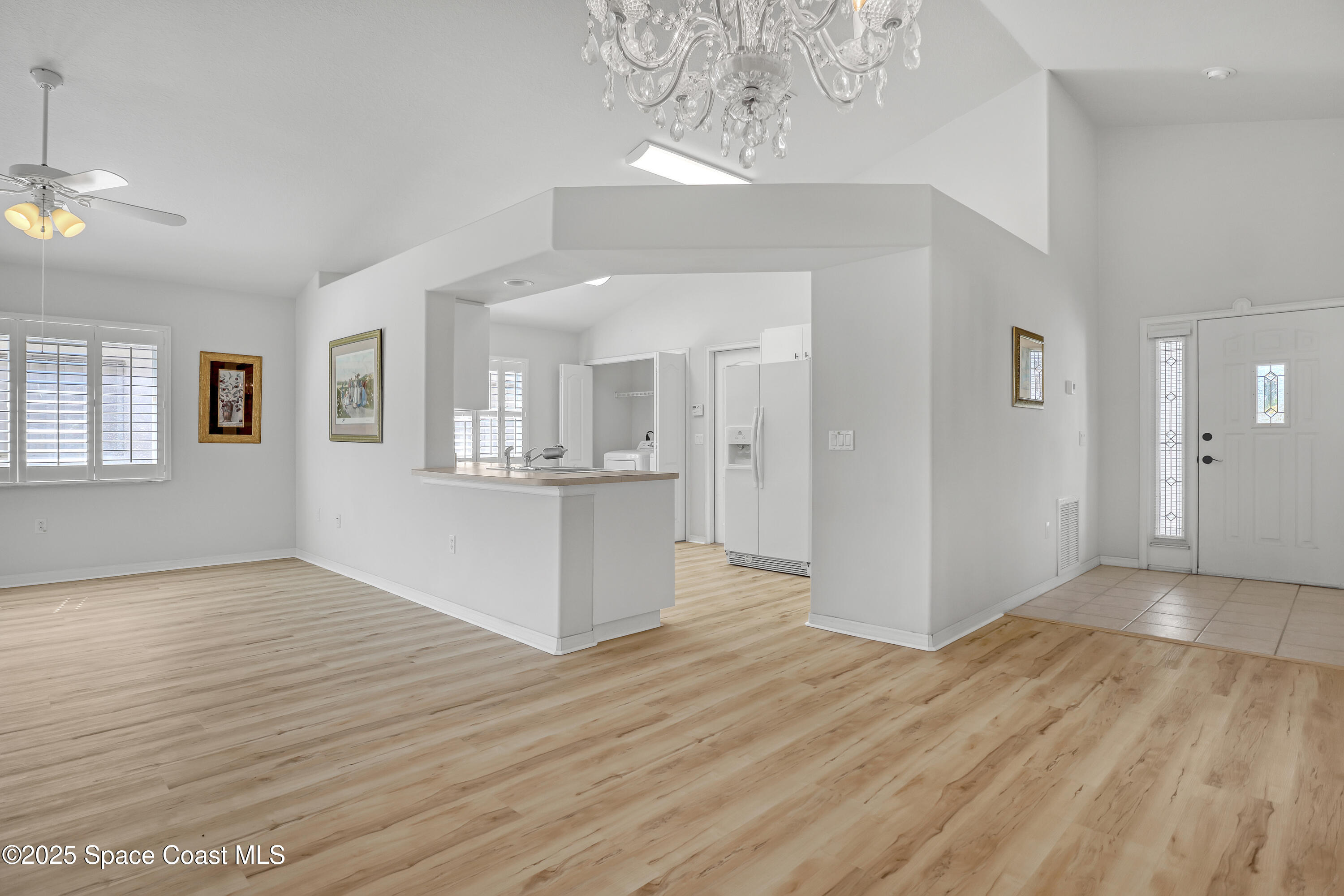 1692 Keys Gate Drive Melbourne, FL 32940 - Photo 6 of 26 a view of a kitchen with wooden floor and a kitchen