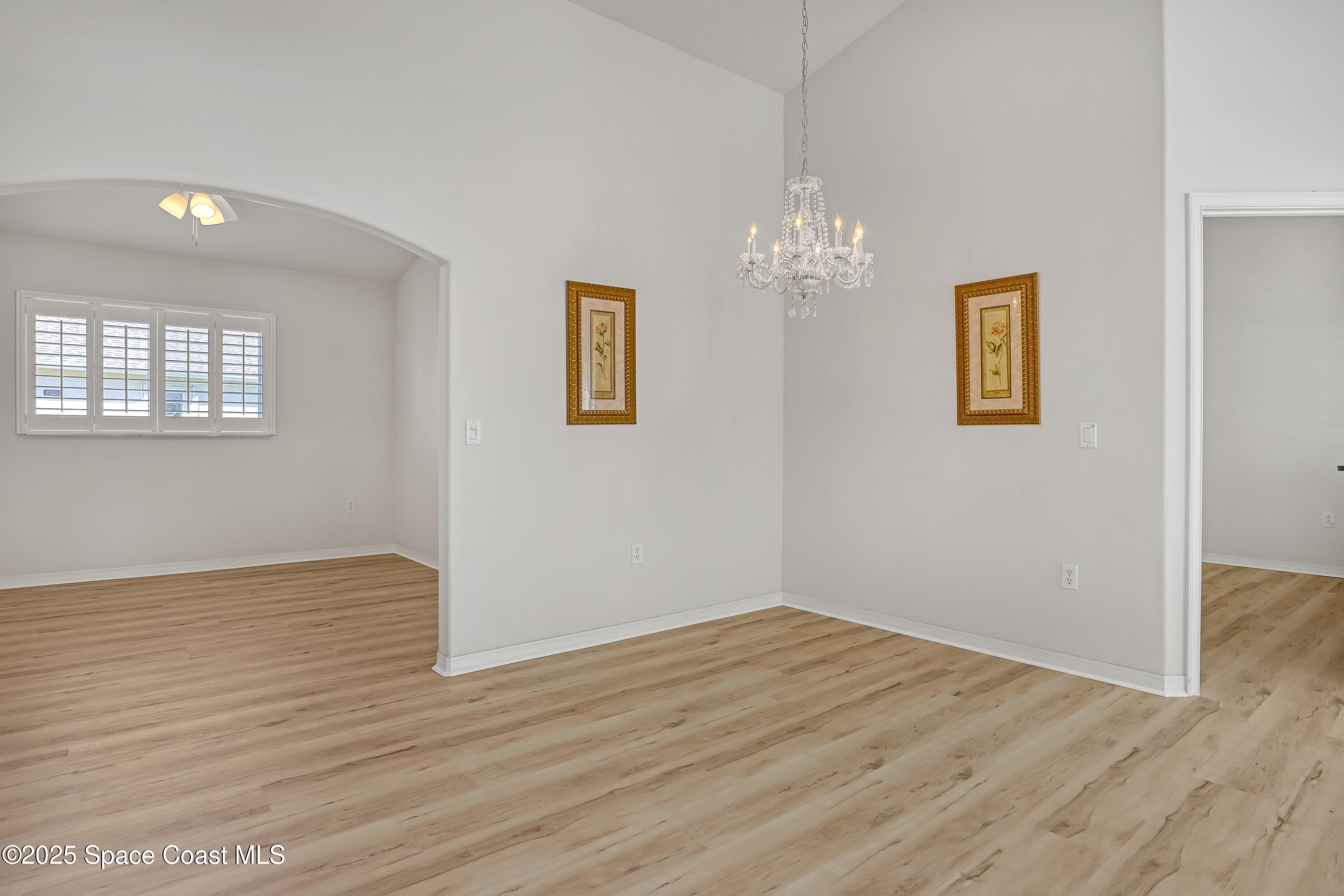 1692 Keys Gate Drive Melbourne, FL 32940 - Photo 7 of 26 a view of an empty room with wooden floor and a window