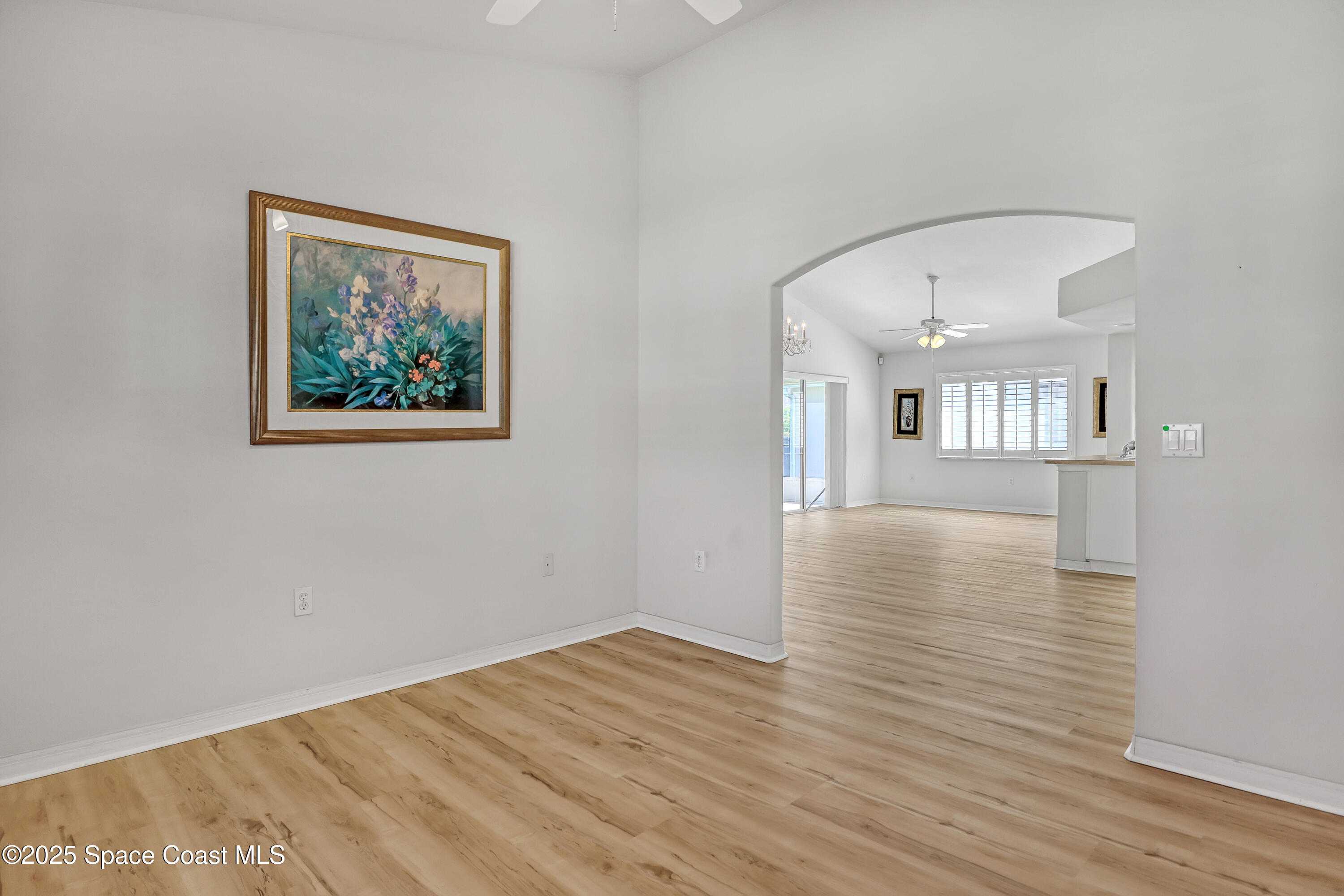 1692 Keys Gate Drive Melbourne, FL 32940 - Photo 10 of 26 a view of an empty room with wooden floor and a large window