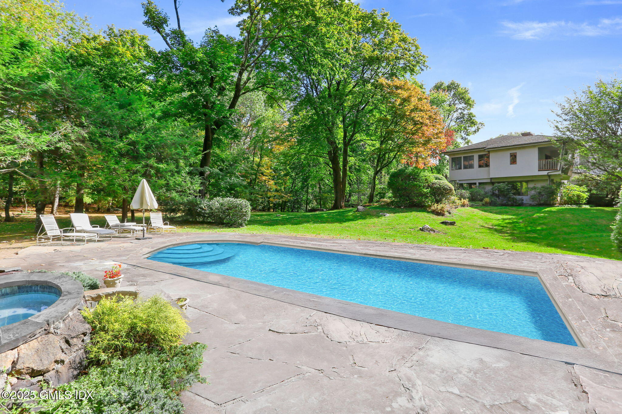 43 Sterling Road South Greenwich, CT 06831 - Photo 6 of 45 a view of a swimming pool with a yard and large trees