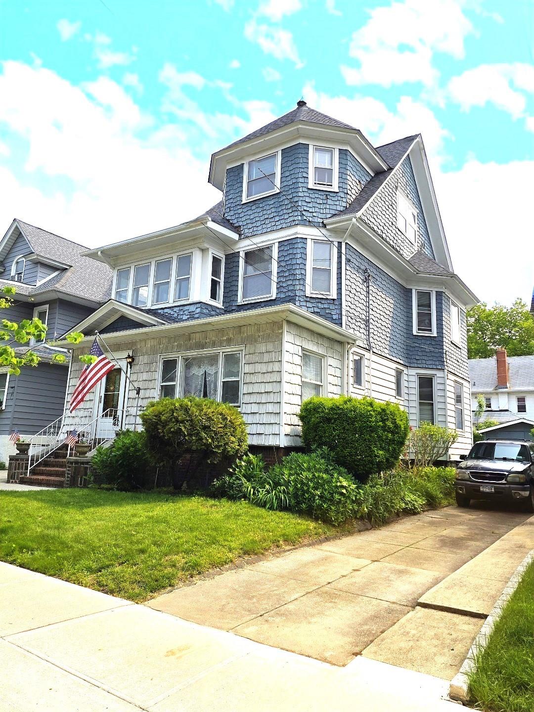 a front view of a residential apartment building with a yard