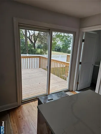 a view of a room with wooden floor