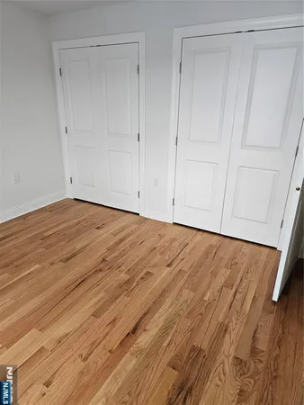 a view of room with wooden floor