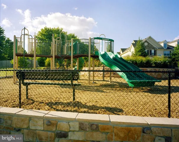 a view of a house with a yard and wooden fence