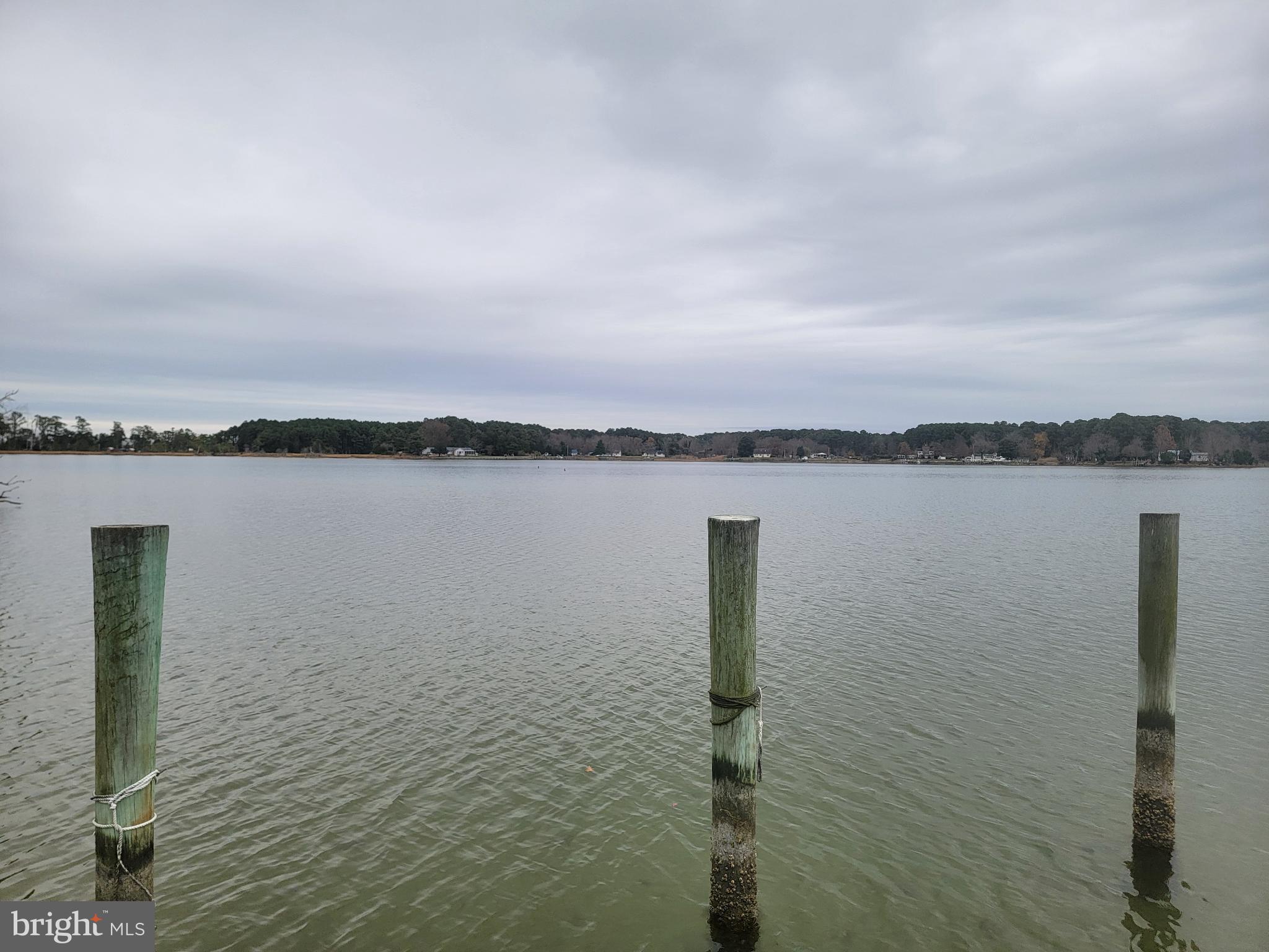 49993 Airedele Road Ridge, MD 20680 - Photo 11 of 34 Serene waters under a cloudy sky.