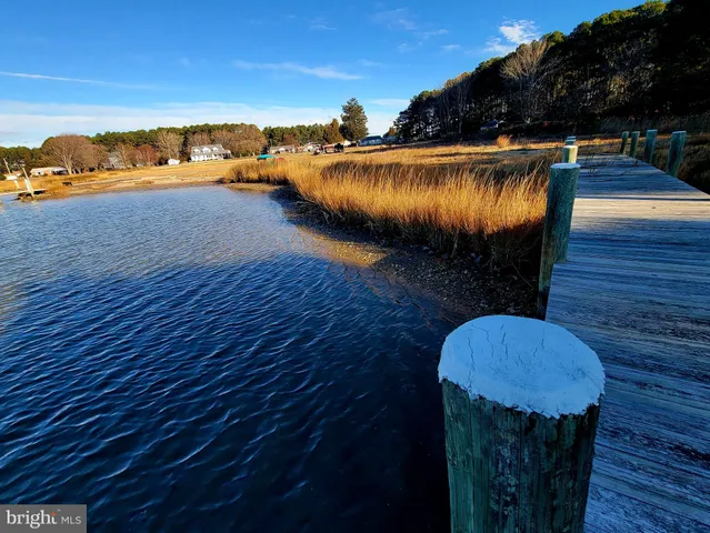 a kitchen with sink a refrigerator and chairs