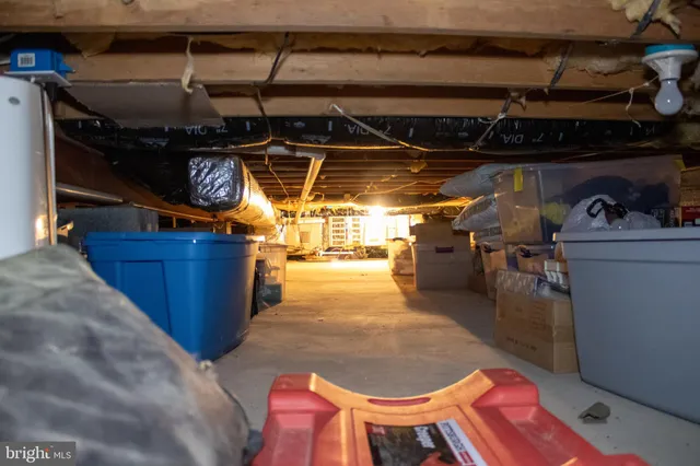 a kitchen with stainless steel appliances granite countertop a stove a refrigerator a sink a dining table and chairs with wooden floor