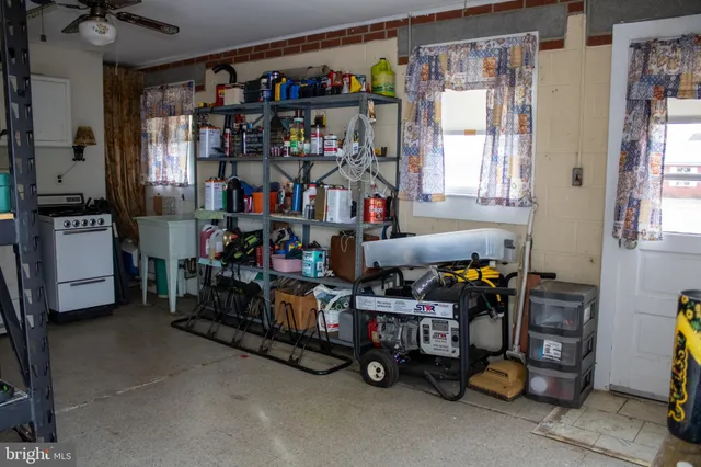a view of a hallway with wooden floor and furniture