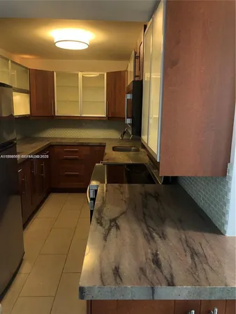 a kitchen with a sink a stove and cabinets