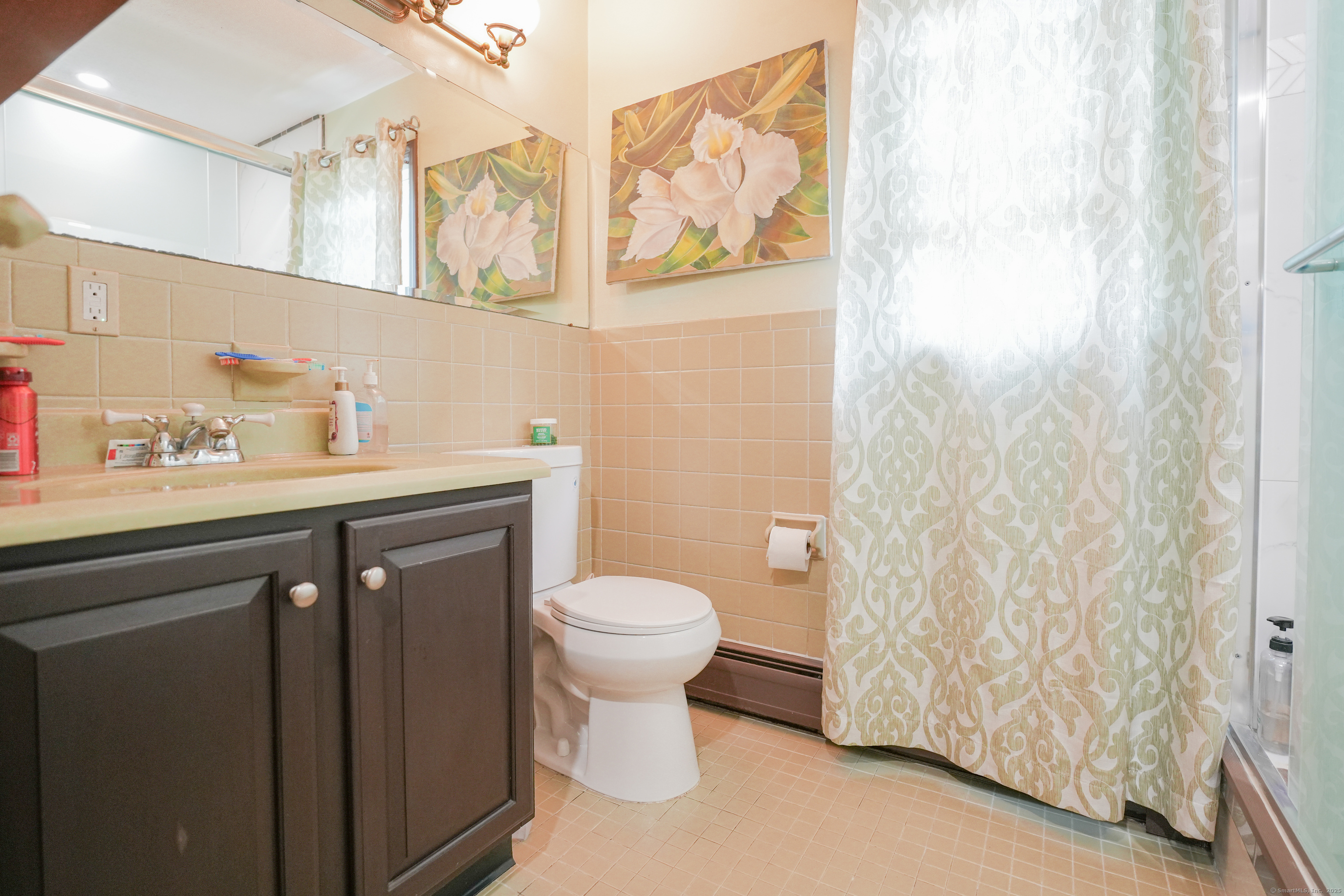 22 Standish Road New Milford, CT 06776 - Photo 2 of 11 a bathroom with a sink a toilet and a shower curtain