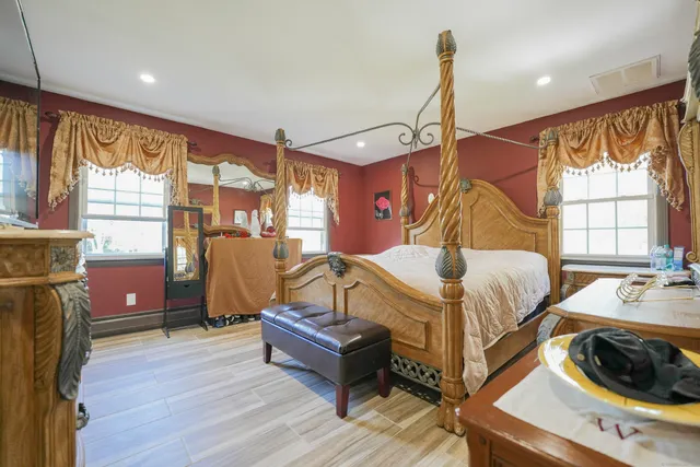 a bedroom with a bed and wooden floor