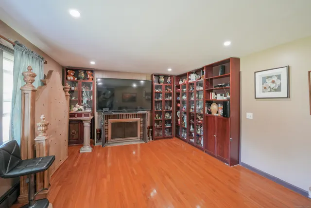 a open kitchen with stainless steel appliances a refrigerator and a flat screen tv