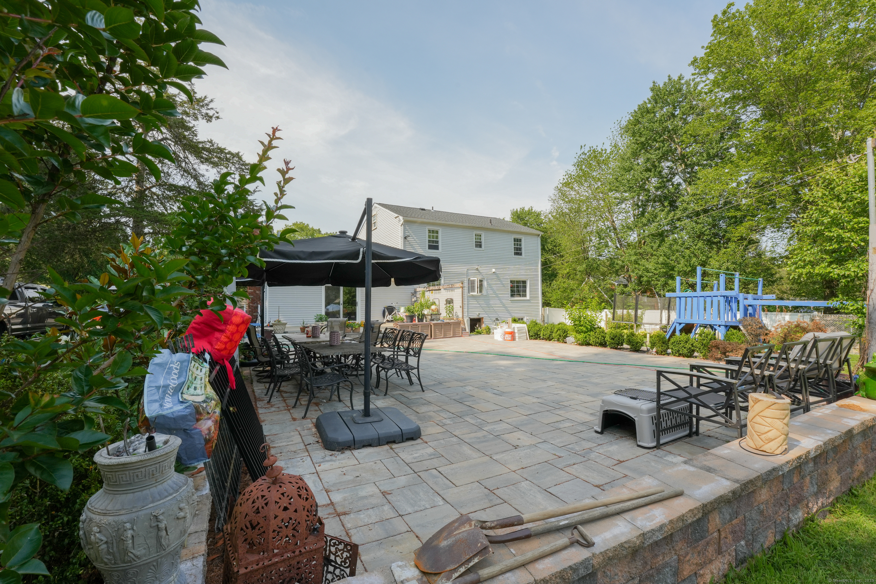 22 Standish Road New Milford, CT 06776 - Photo 10 of 11 a view of a patio with table and chairs potted plants with wooden fence