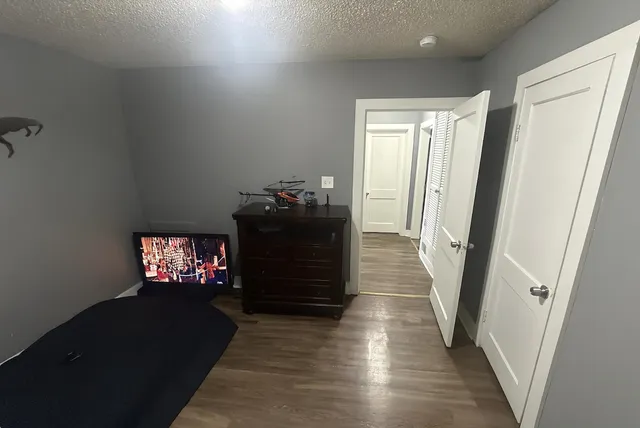a view of a hallway to a livingroom with furniture