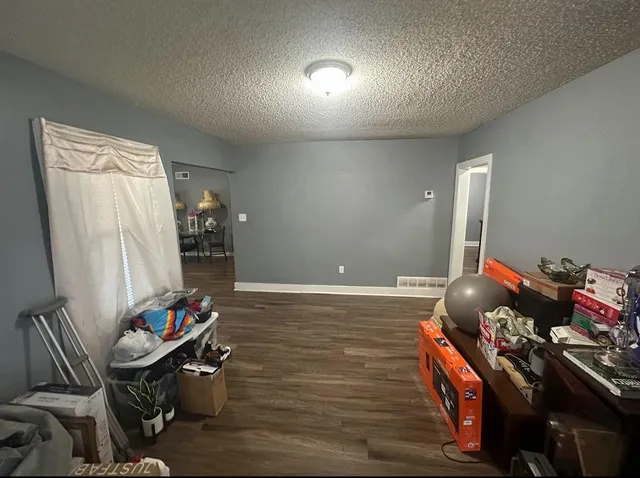 a view of a room with wooden floor and furniture
