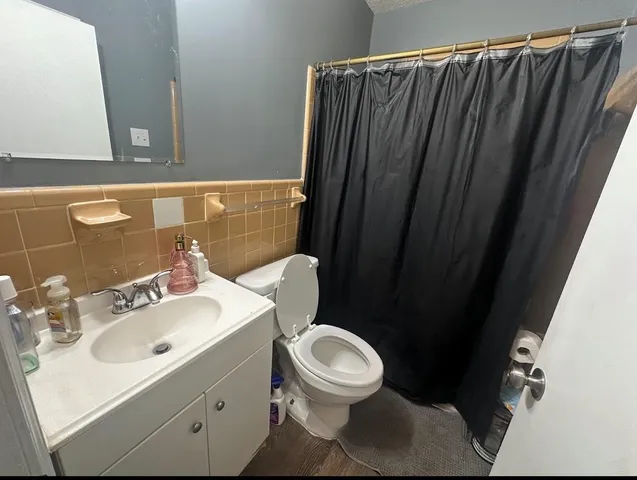 a view of a hallway with wooden floor and a fireplace