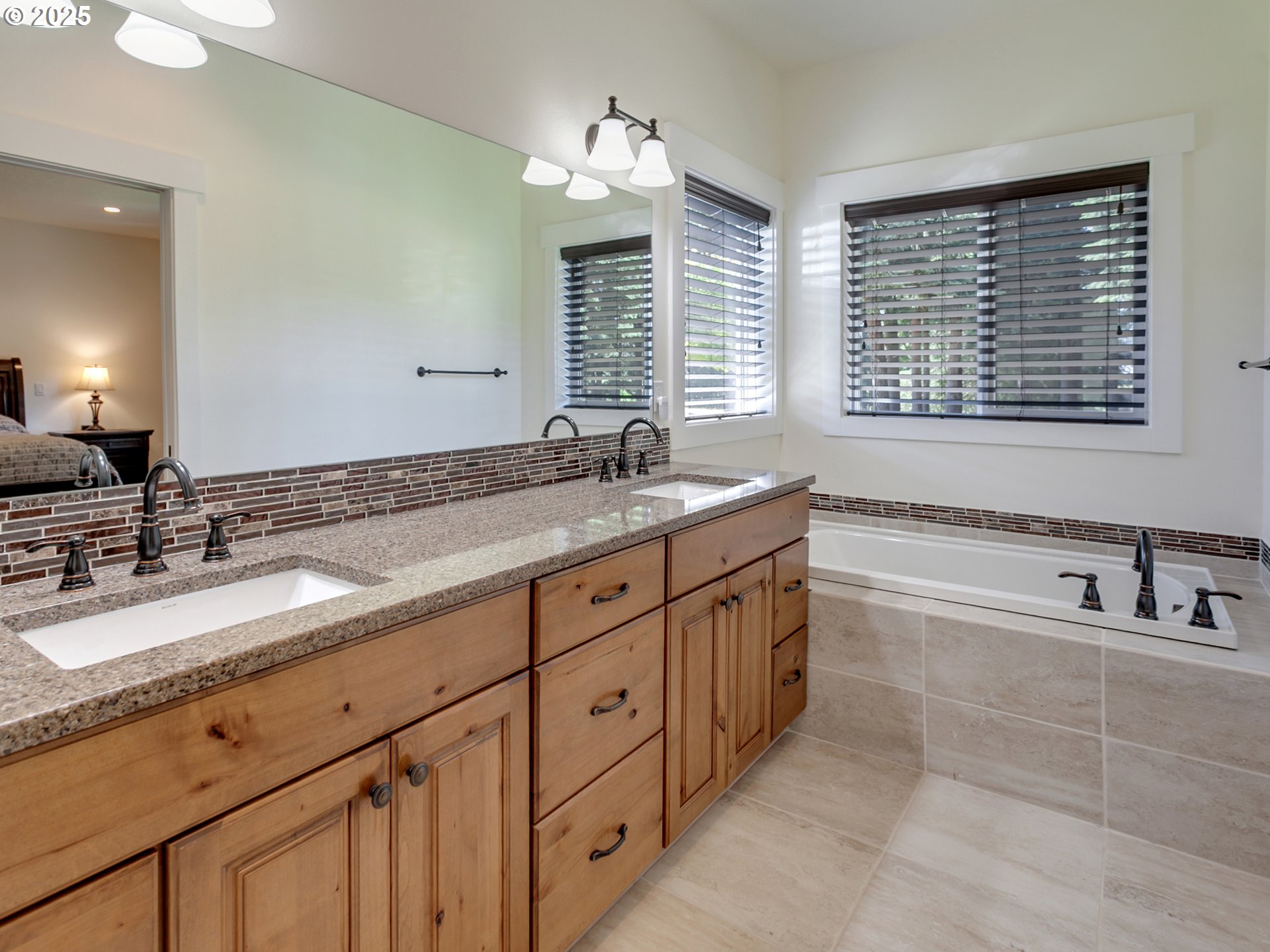 36280 Southeast Hauglum Road Sandy, OR 97055 - Photo 16 of 31 a spacious bathroom with double vanity sink a bathtub and next to a window