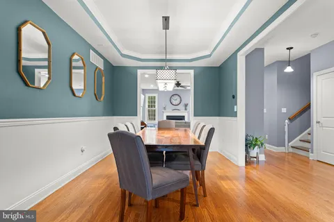 a view of a dining room with furniture wooden floor and chandelier