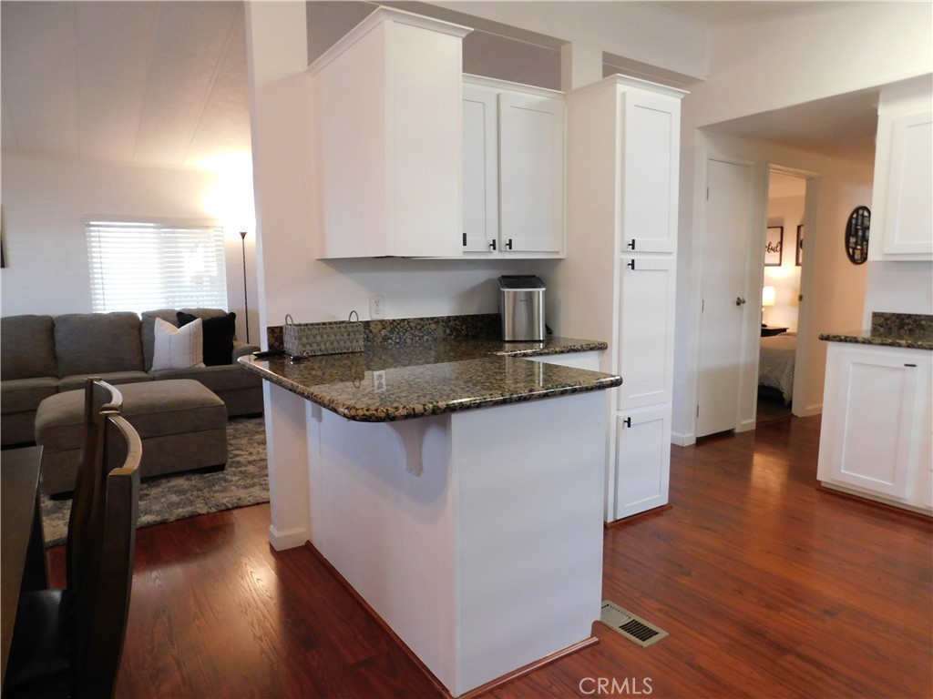 4170 Needles Highway, Unit 55 Needles, CA 92363 - Photo 11 of 39 a kitchen with a refrigerator and a stove top oven