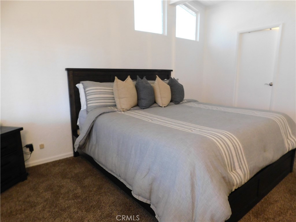 4170 Needles Highway, Unit 55 Needles, CA 92363 - Photo 14 of 39 a bed sitting in a bedroom next to a window