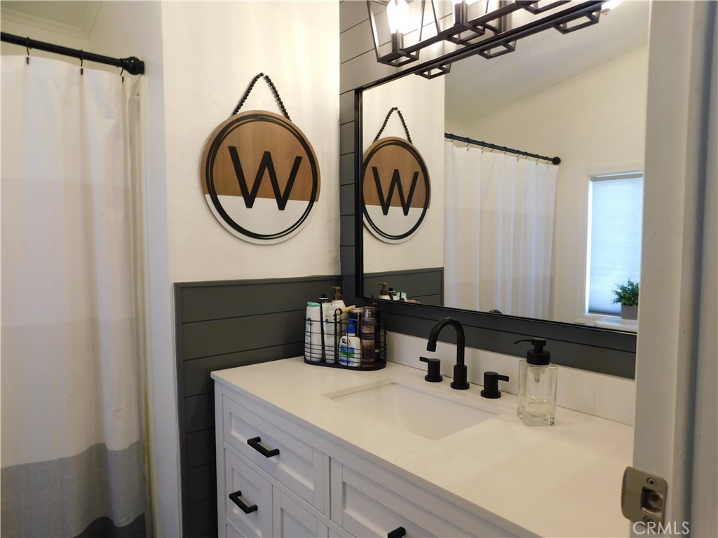 4170 Needles Highway, Unit 55 Needles, CA 92363 - Photo 15 of 39 a bathroom with a sink and a mirror