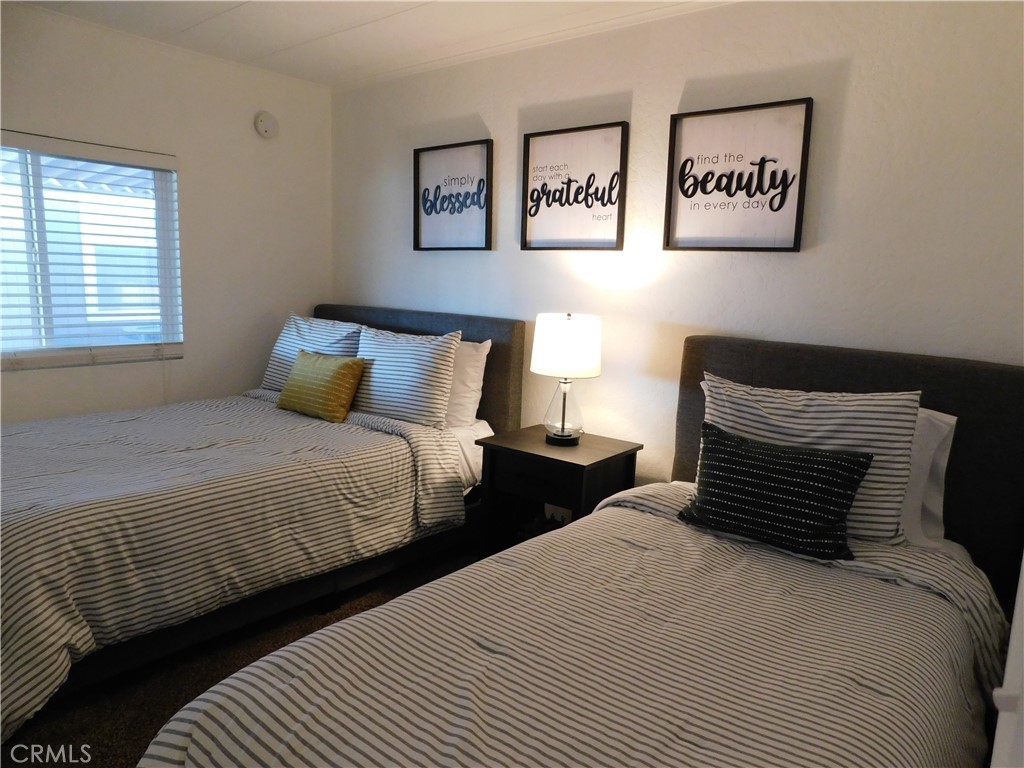 4170 Needles Highway, Unit 55 Needles, CA 92363 - Photo 17 of 39 a bedroom with double bed and two windows