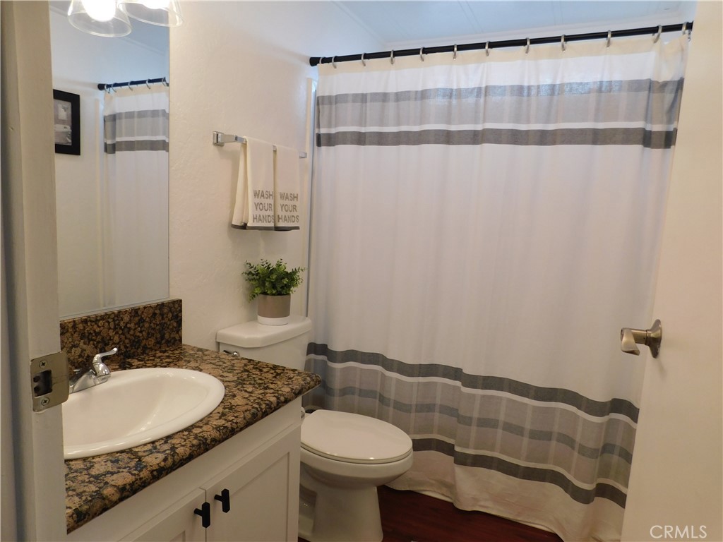 4170 Needles Highway, Unit 55 Needles, CA 92363 - Photo 18 of 39 a bathroom with a granite countertop sink and a mirror