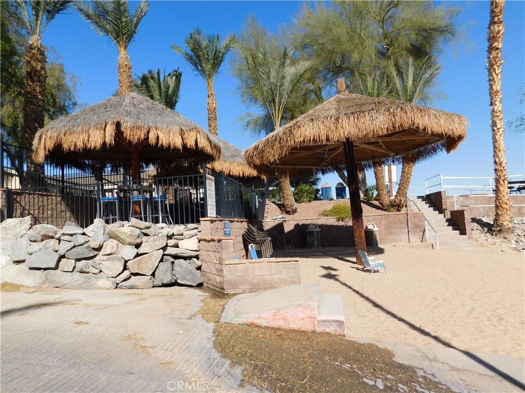 4170 Needles Highway, Unit 55 Needles, CA 92363 - Photo 38 of 39 a view of a patio with a table and chairs under an umbrella