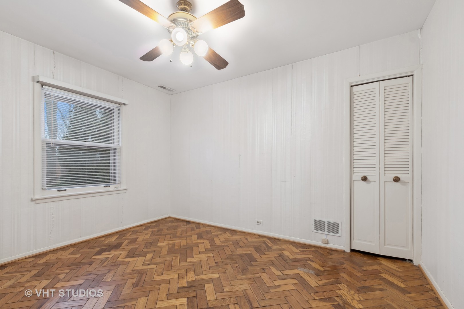 835 Heather Road Deerfield, IL 60015 - Photo 12 of 29 an empty room with chandelier fan and windows
