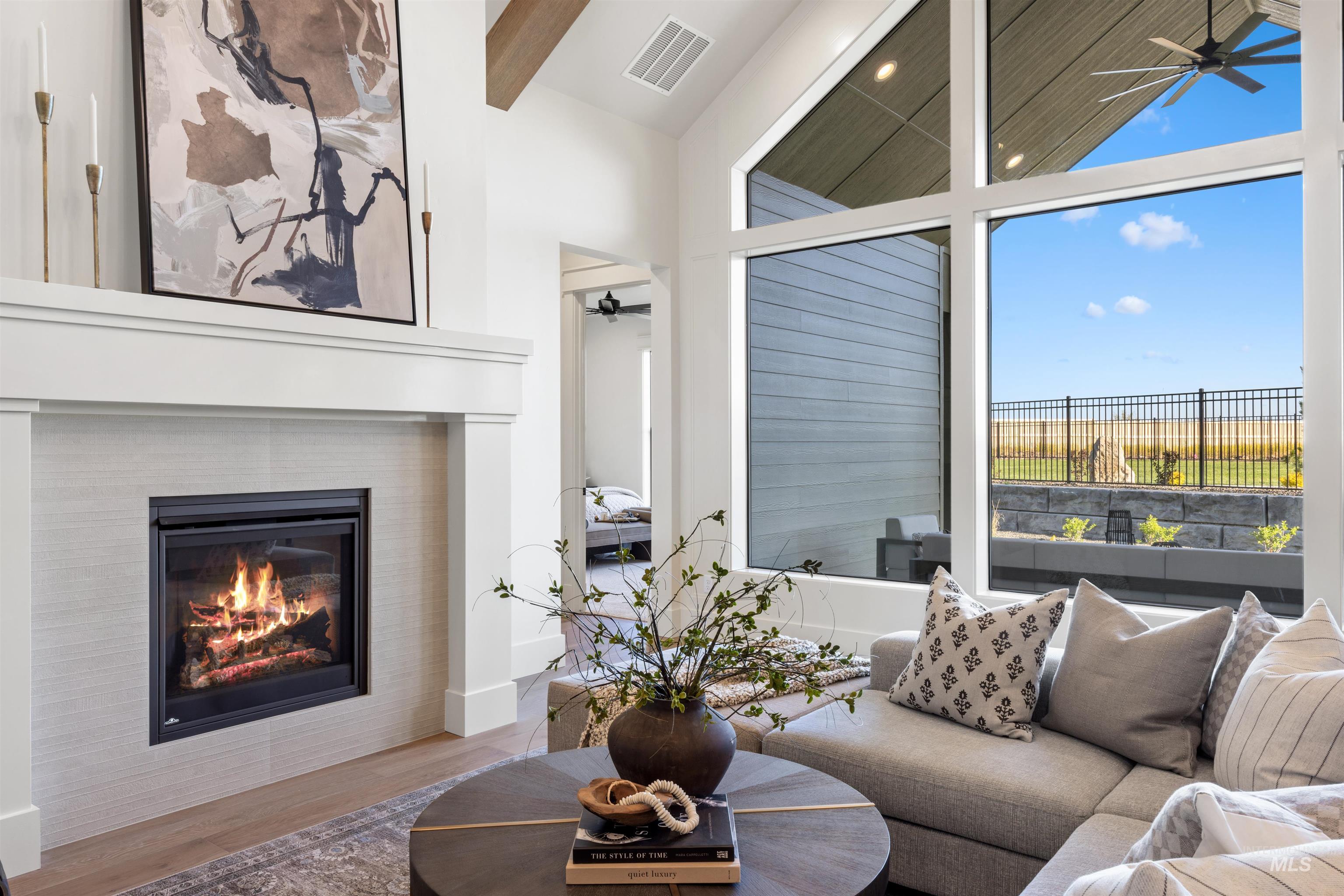 1064 East Snag Street Meridian, ID 83642 - Photo 15 of 44 Living room with ceiling fan, a tile fireplace, wood finished floors, lofted ceiling, and recessed lighting
