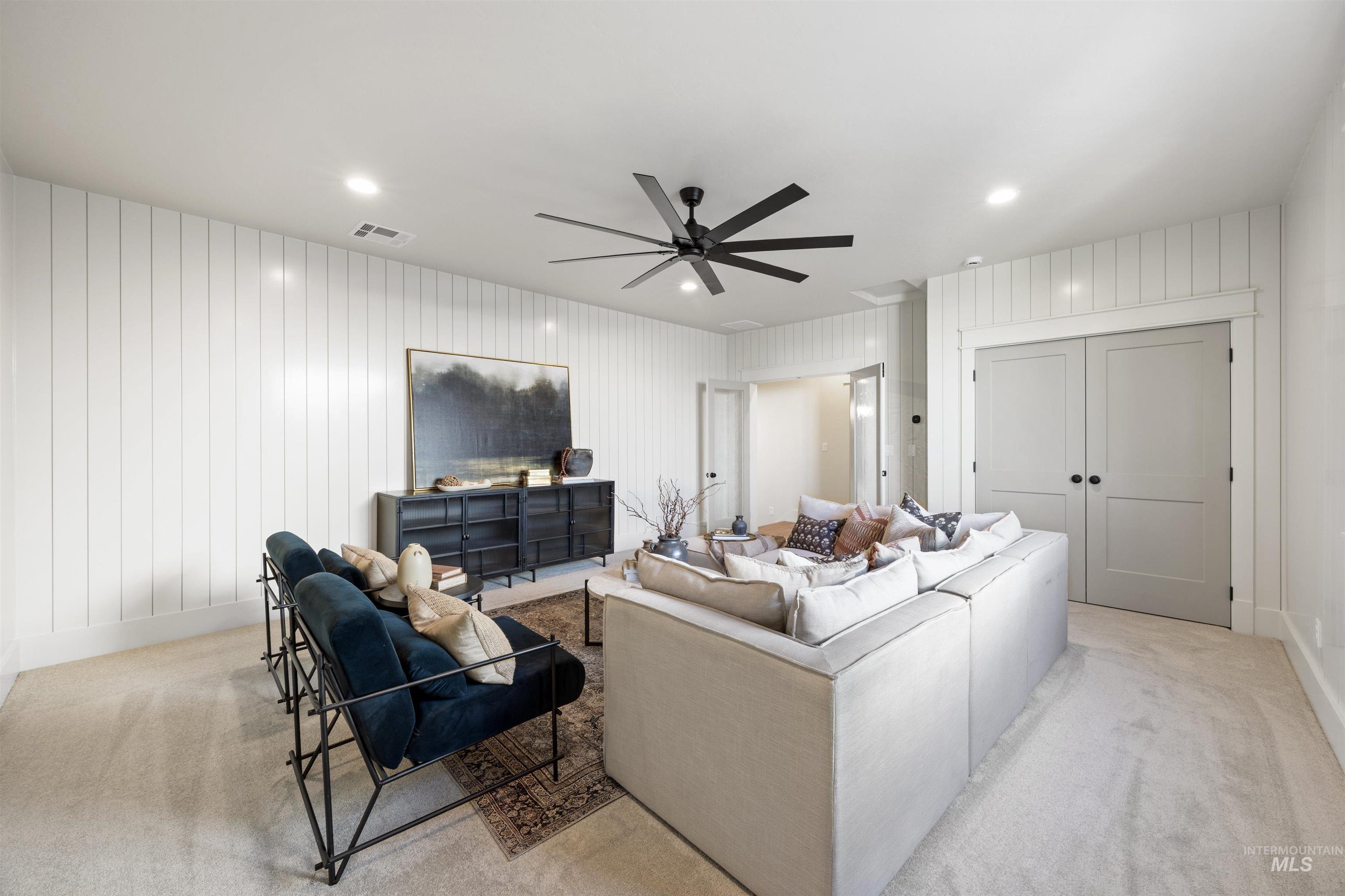 1064 East Snag Street Meridian, ID 83642 - Photo 40 of 44 Living room with light colored carpet, a ceiling fan, and recessed lighting
