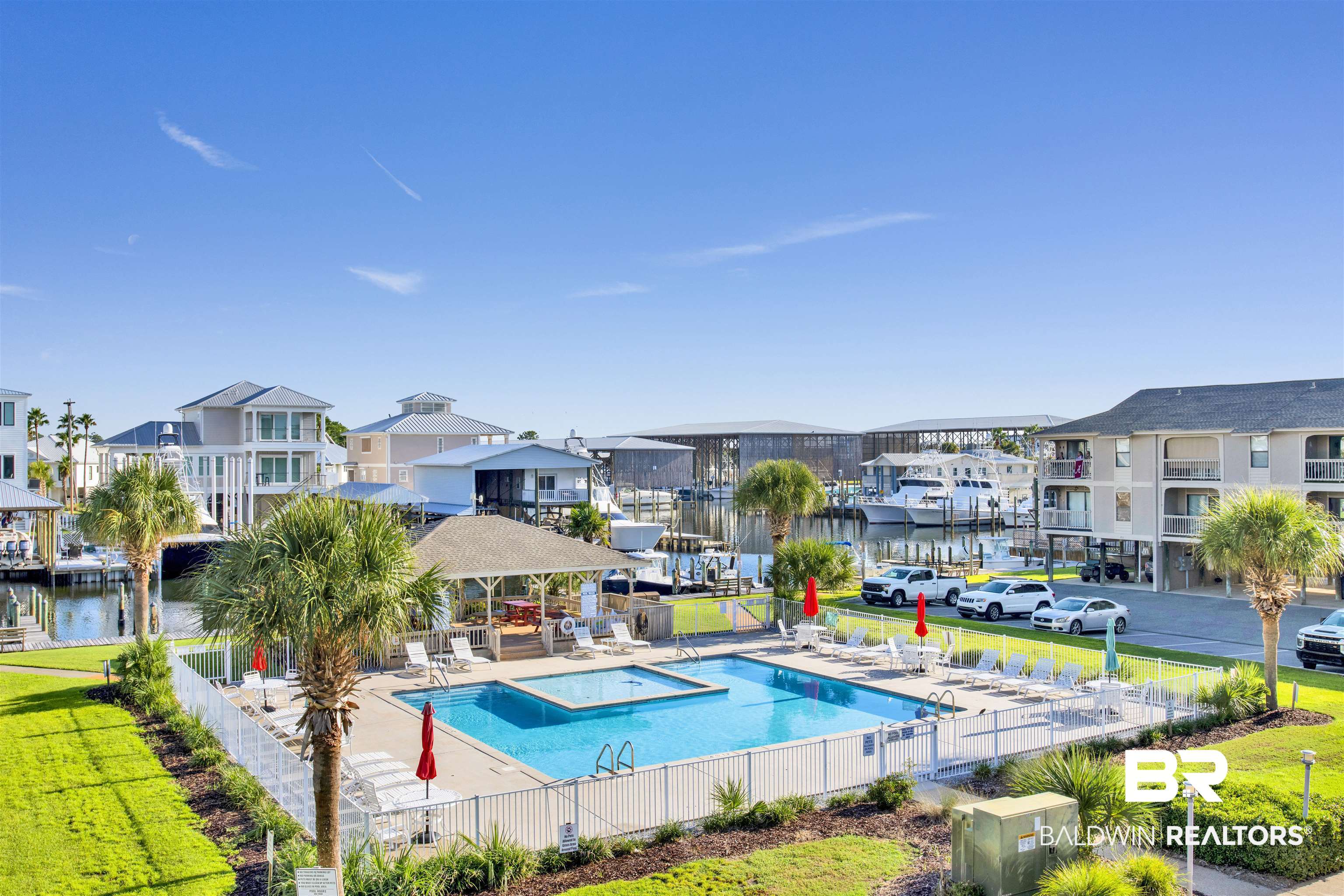 26913 Marina Road, Unit 213 Orange Beach, AL 36561 - Photo 3 of 30 View of pool featuring a water view and a lawn