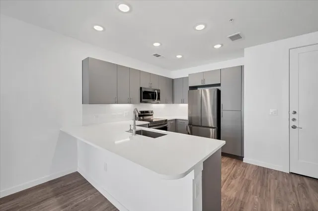 a kitchen with refrigerator cabinets and wooden floor