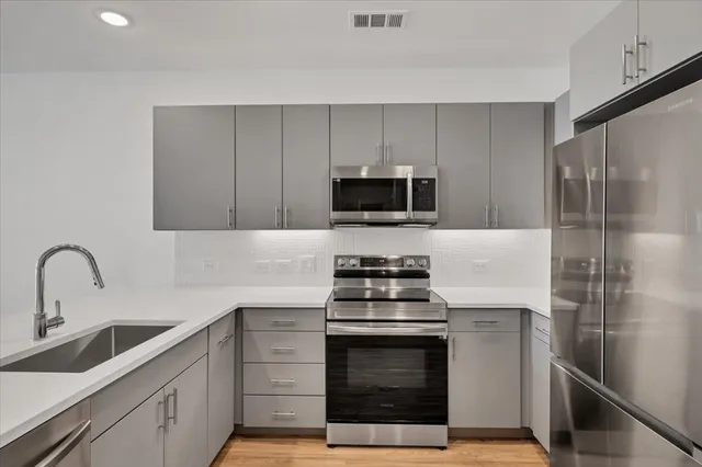 a kitchen with a sink stove and refrigerator