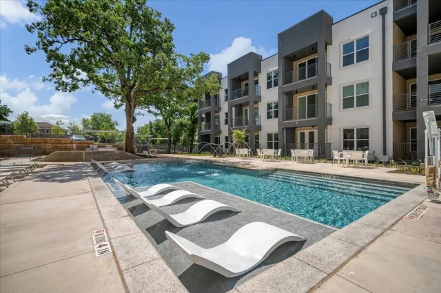 a front view of a residential apartment building with a yard