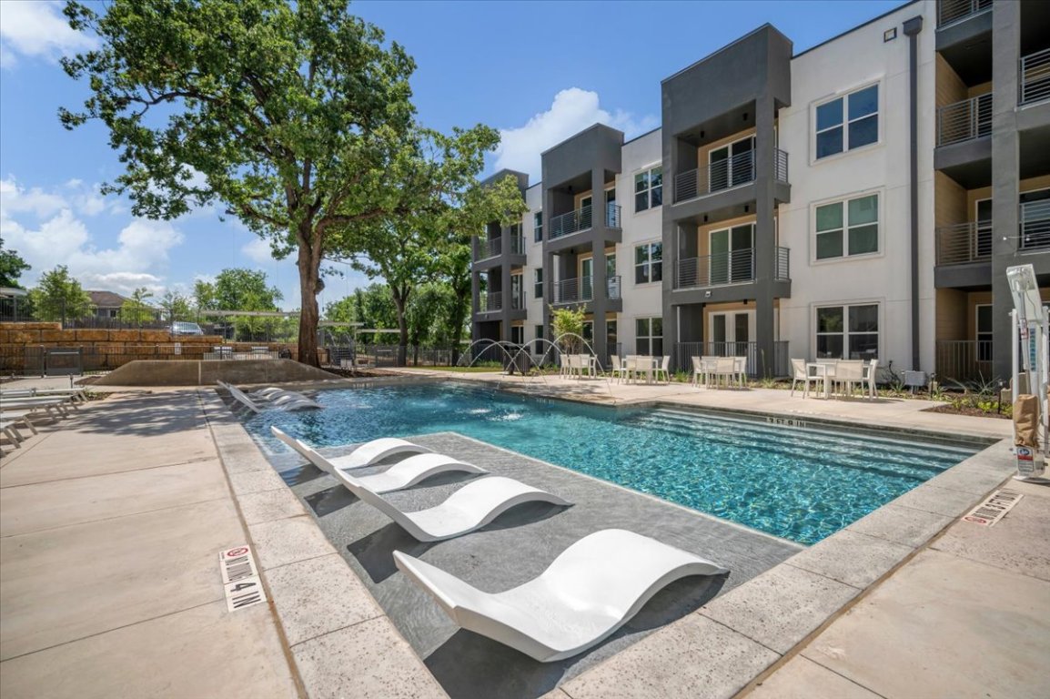 4801 Springdale Road, Unit 1402 Austin, TX 78723 - Photo 31 of 40 a front view of a residential apartment building with a yard