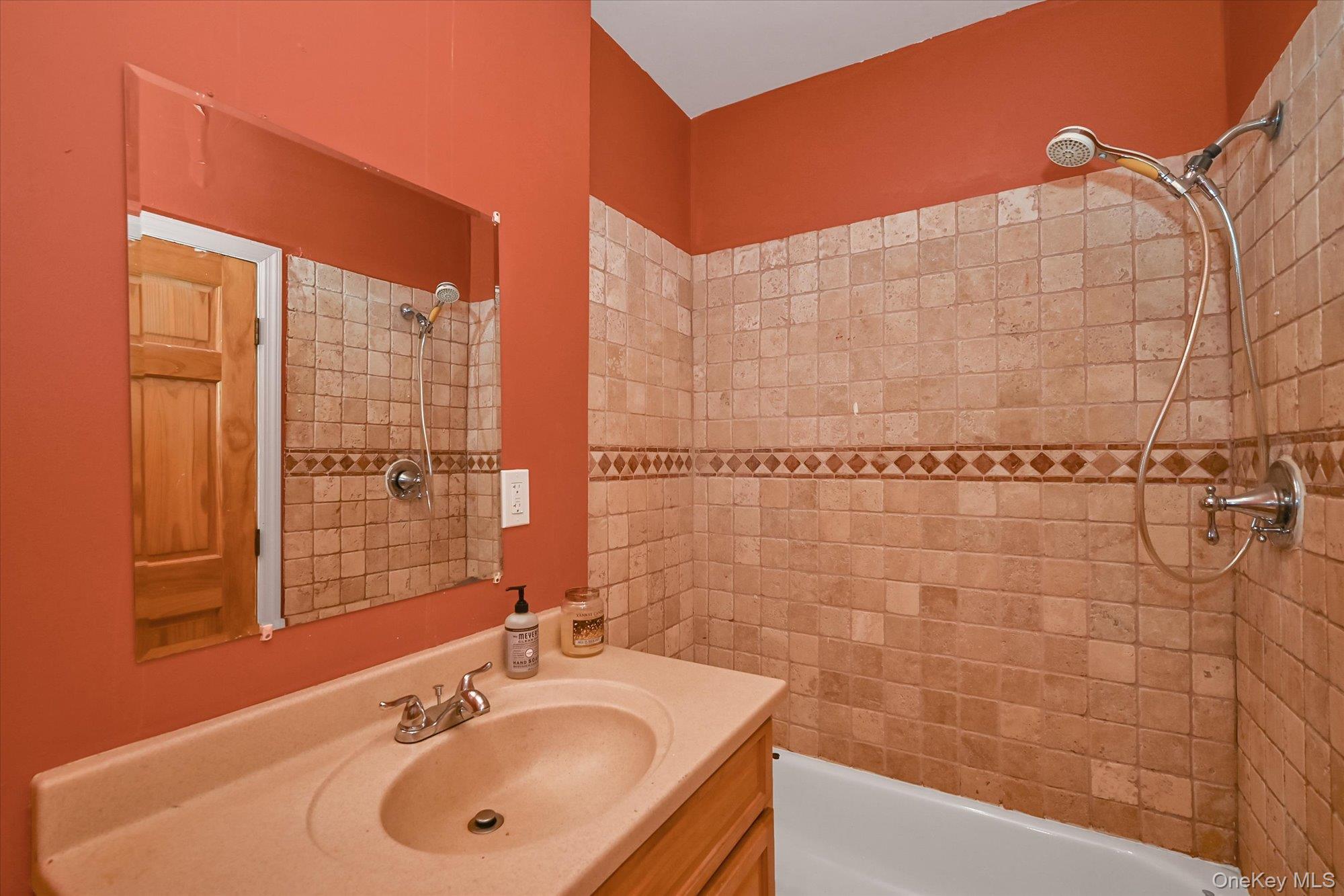 69-25 59th Road Queens, NY 11378 - Photo 11 of 24 Bathroom with bathtub / shower combination and vanity