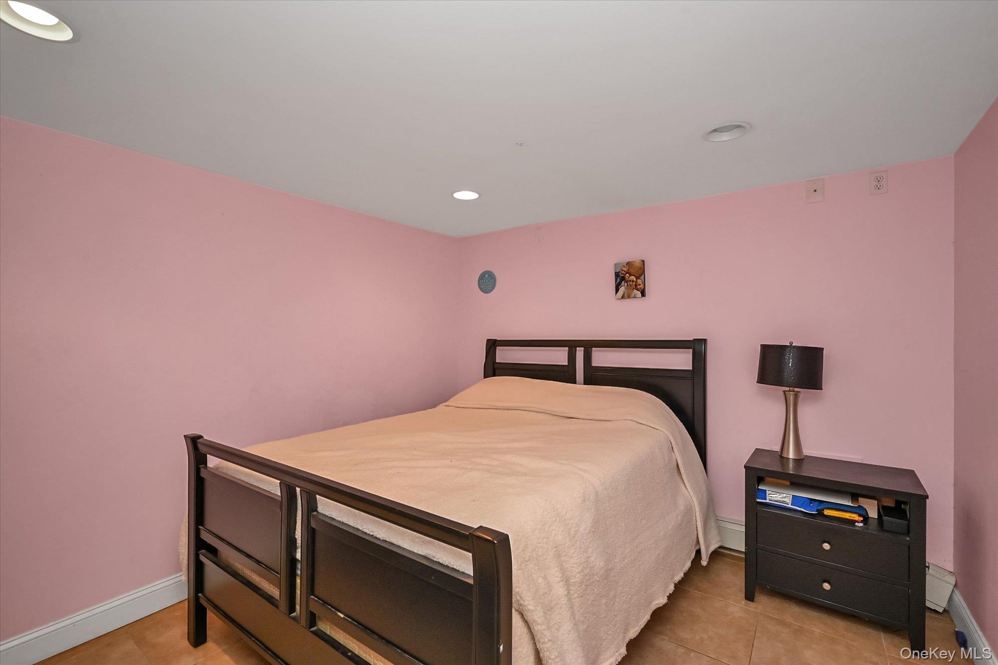 69-25 59th Road Queens, NY 11378 - Photo 18 of 24 Bedroom featuring recessed lighting and light tile patterned floors