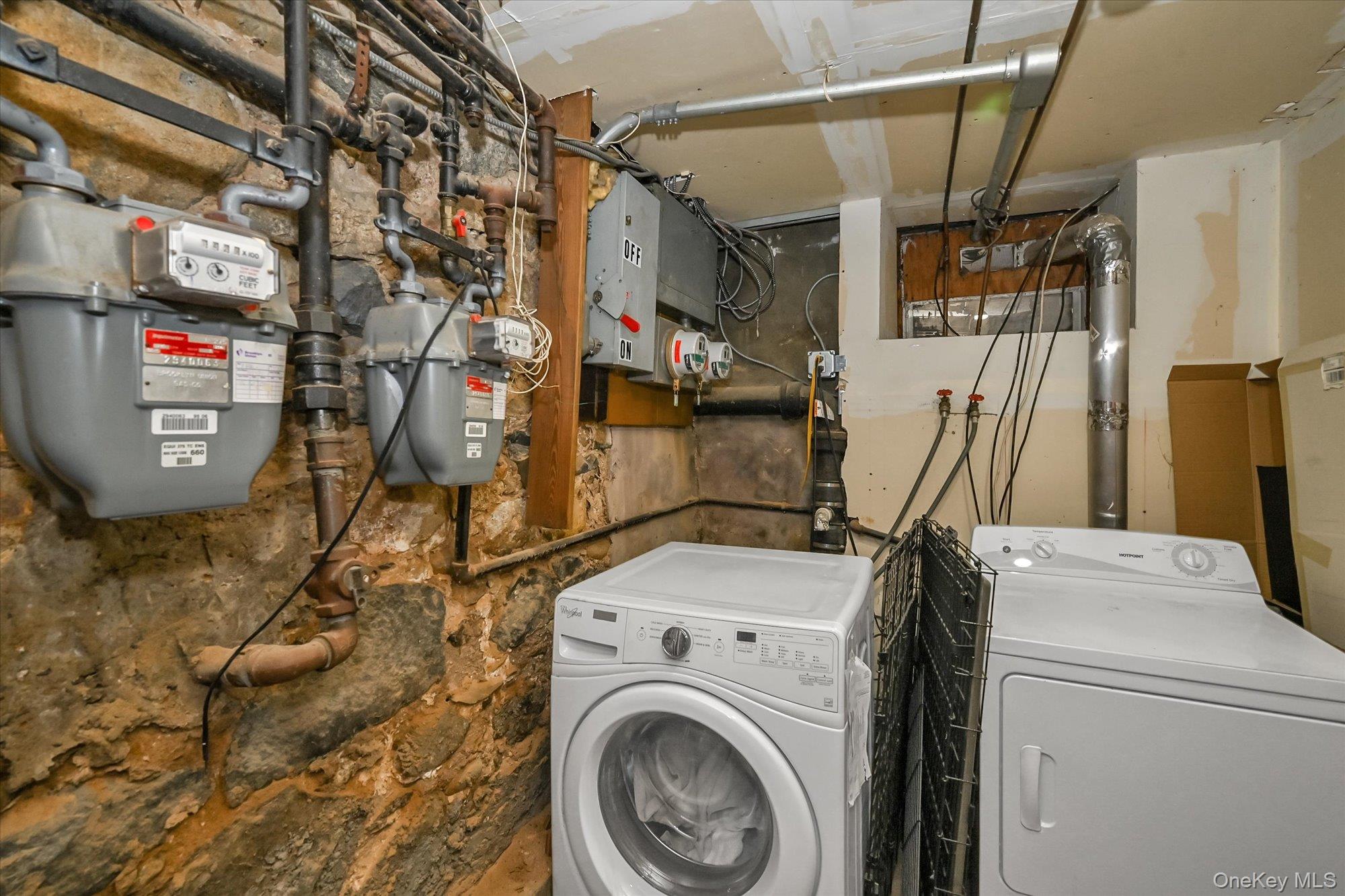 69-25 59th Road Queens, NY 11378 - Photo 21 of 24 Laundry room featuring washer and clothes dryer