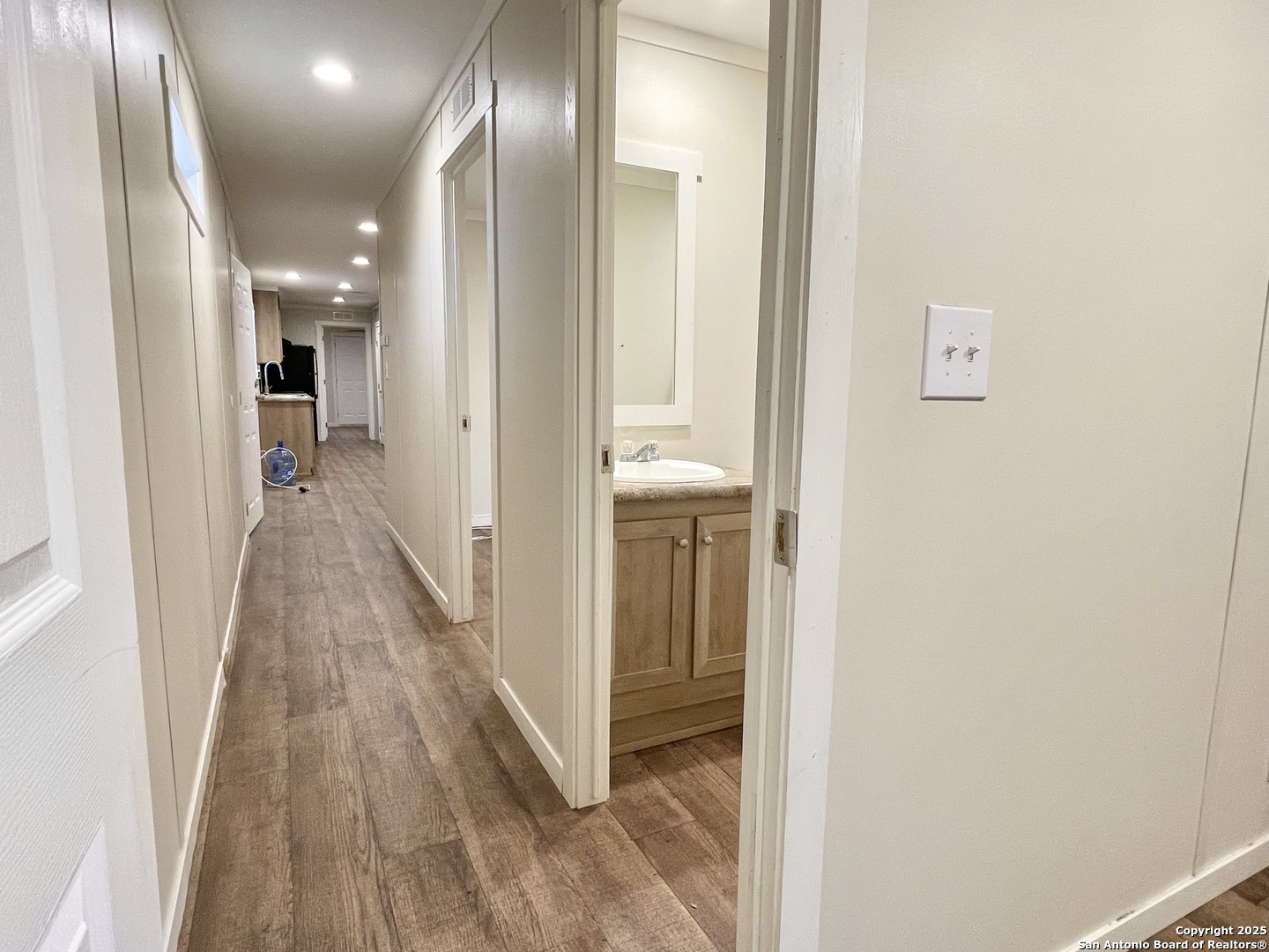 7970 1st Street Somerset, TX 78069 - Photo 18 of 32 a view of a hallway with wooden floor