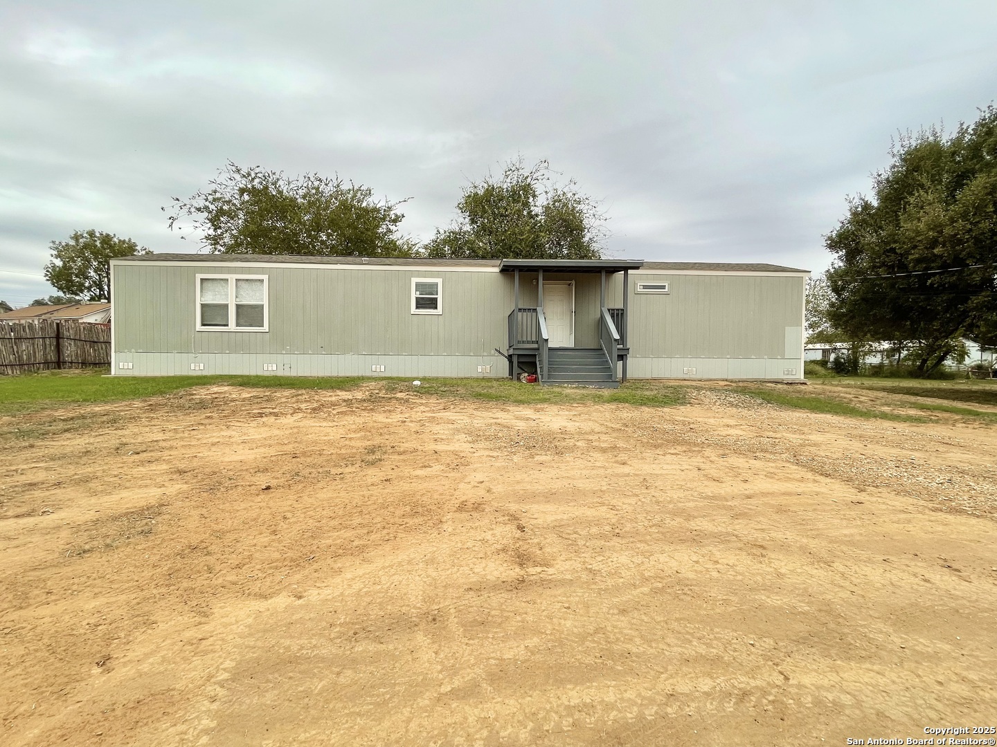 7970 1st Street Somerset, TX 78069 - Photo 9 of 32 a view of a yard with a garage