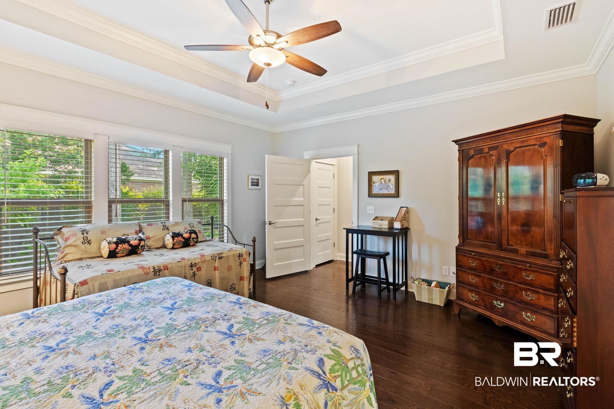 192 Mark Twain Loop Foley, AL 36535 - Photo 20 of 42 Bedroom featuring ceiling fan, crown molding, dark hardwood / wood-style flooring, and a raised ceiling