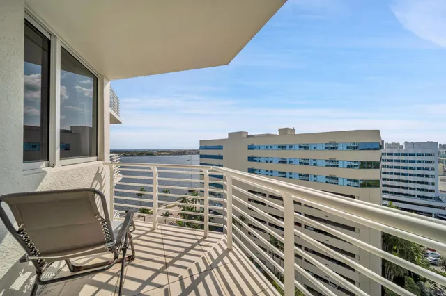 a view of a balcony with an outdoor seating